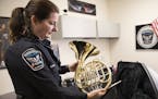 Officer Beverly Price shows off a donated french horn inside her office at Nicollet Middle School in Burnsville] (Leila Navidi/Star Tribune) leila.nav