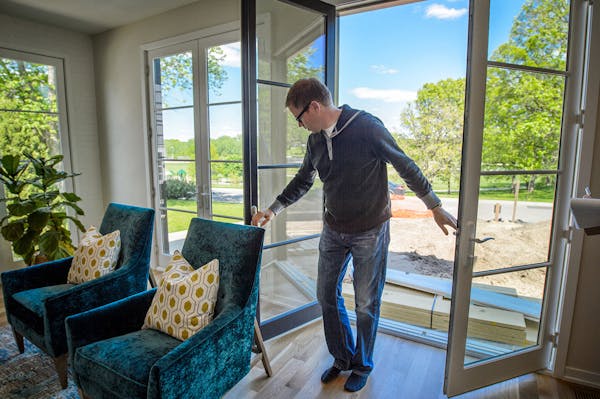 Builder Andy Porter of Refined opens the double French doors in a new $1.475 million home featured on this month's Artisan Home Tour. The tour runs th