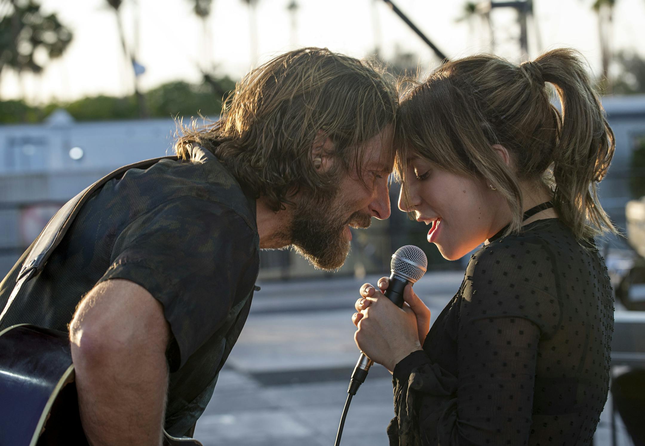 This image released by Warner Bros. shows Bradley Cooper, left, and Lady Gaga in a scene from the latest reboot of the film, "A Star is Born." (Neal Preston/Warner Bros. via AP)