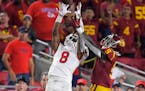 Fresno State wide receiver Chris Coleman, left, catches a pass while under pressure from Southern California cornerback Greg Johnson