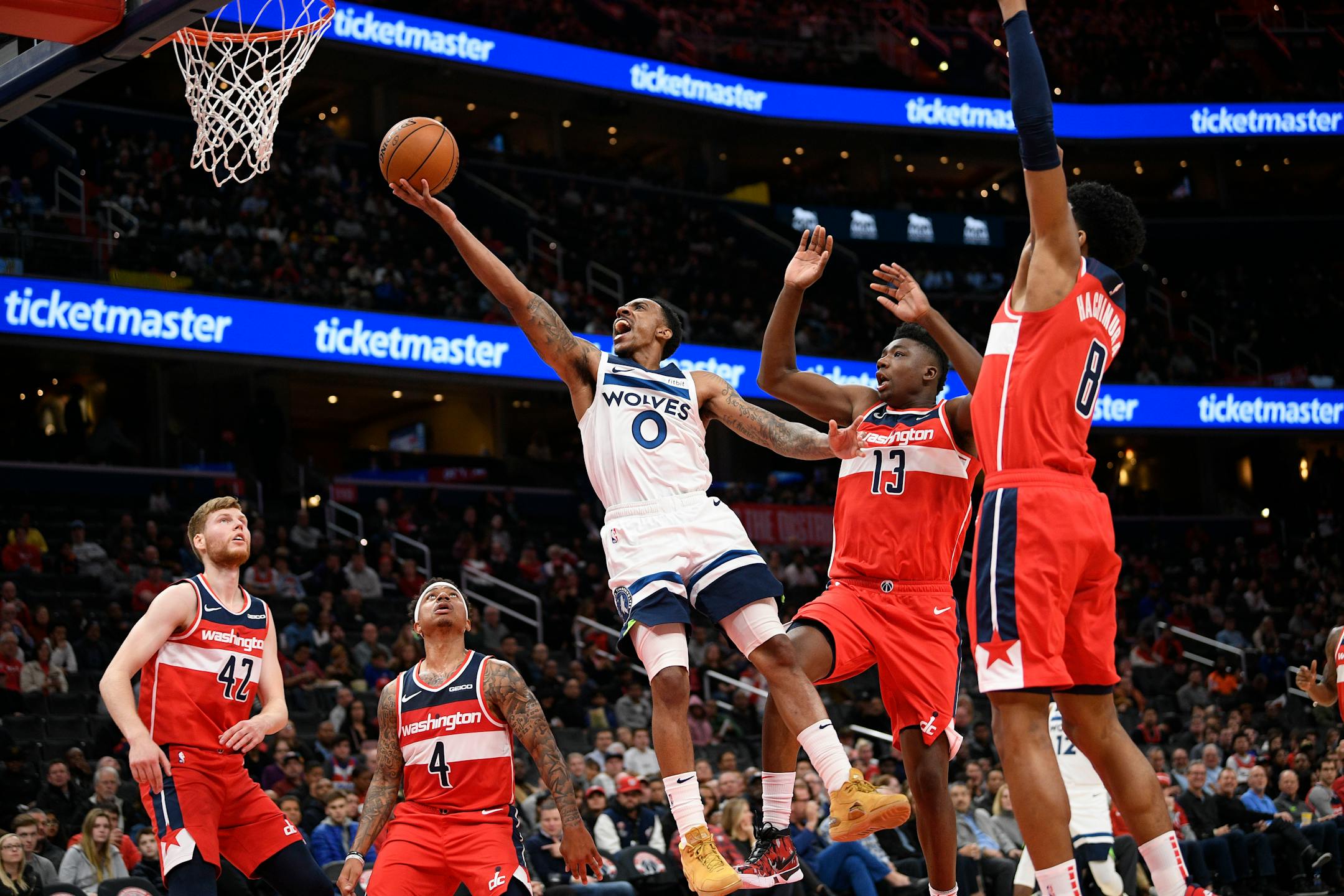 Timberwolves guard Jeff Teague goes to the basket past Washington Wizards center Thomas Bryant (13), forward Rui Hachimura (8), forward Davis Bertans (42) and guard Isaiah Thomas (4)