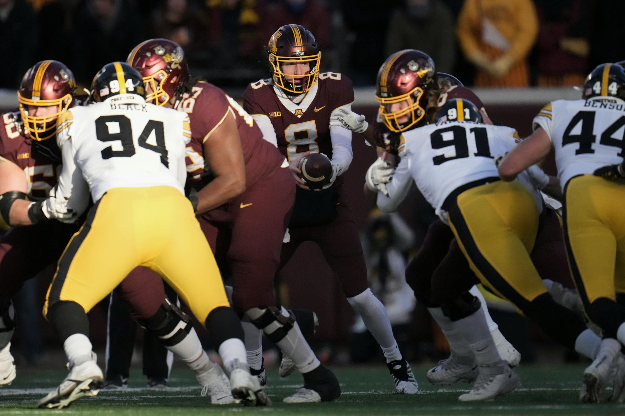 Minnesota Gophers quarterback Athan Kaliakmanis (8) handed the ball to running back Mohamed Ibrahim (24) during a first quarter drive.