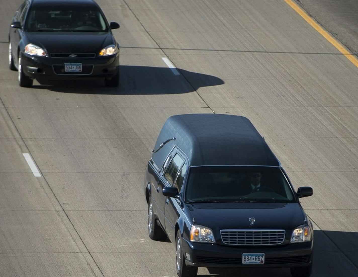 The hearse bringing slain Aitkin County Deputy Steven Sandberg traveled along I-94 in Brooklyn Park on its way to the Twin Cities for an autopsy.