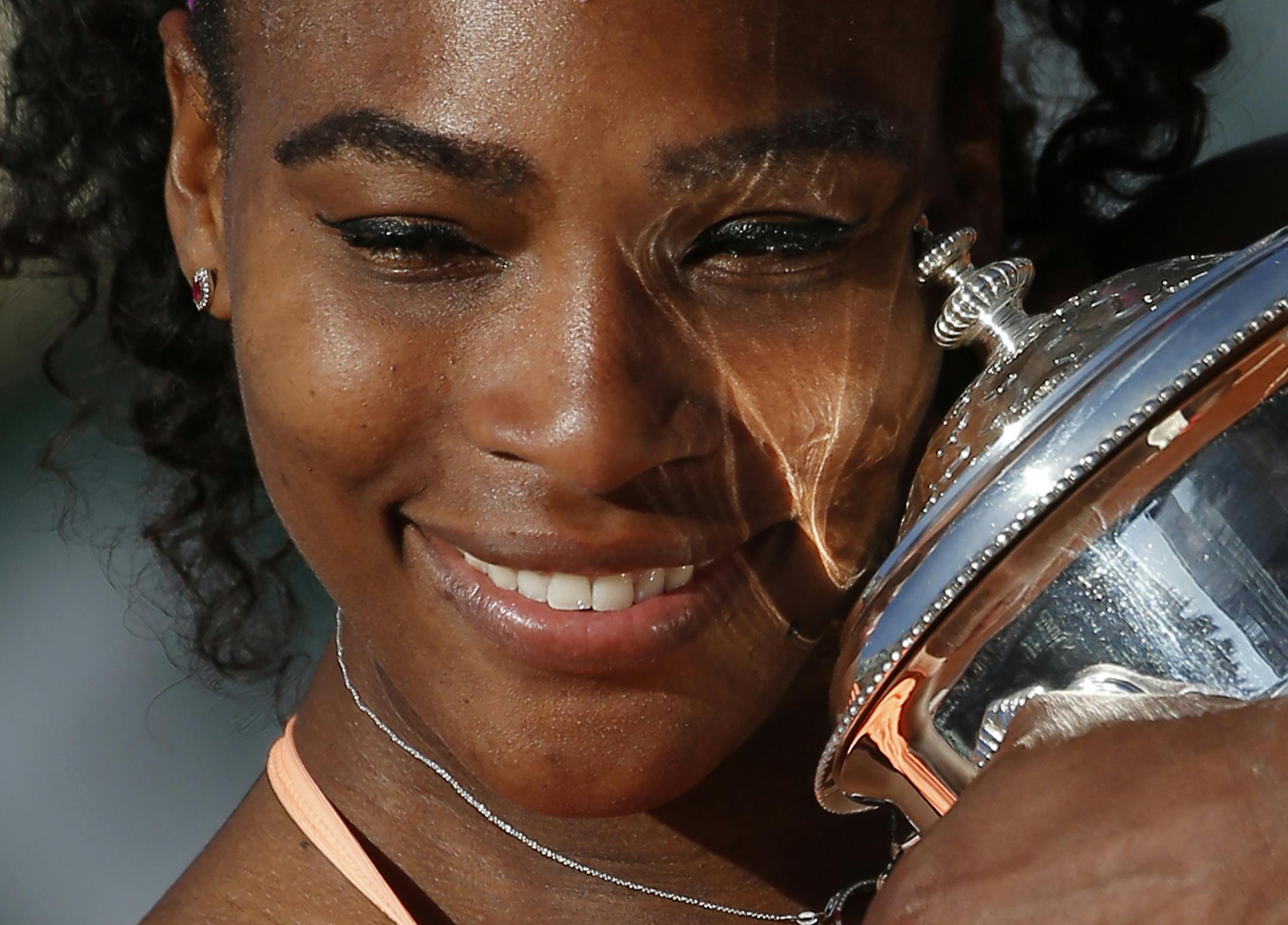 FILE - In this June 6, 2015, file photo, Serena Williams, of the United States, holds the trophy after winning the final of the French Open tennis tournament against Lucie Safarova, of the Czech Republic, at Roland Garros stadium, in Paris. The French Open beginds on Sunday, May 22. The 34-year-old American seeks her 22nd singles title at a Grand Slam tournament, equaling Steffi Graf's record for the Open era, which began in 1968. (AP Photo/Michel Euler, File)