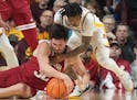 Indiana Hoosiers guard Trey Galloway tries to keep control of a loose ball against Gophers guard Elijah Hawkins in the first half.