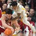 Indiana Hoosiers guard Trey Galloway tries to keep control of a loose ball against Gophers guard Elijah Hawkins in the first half.