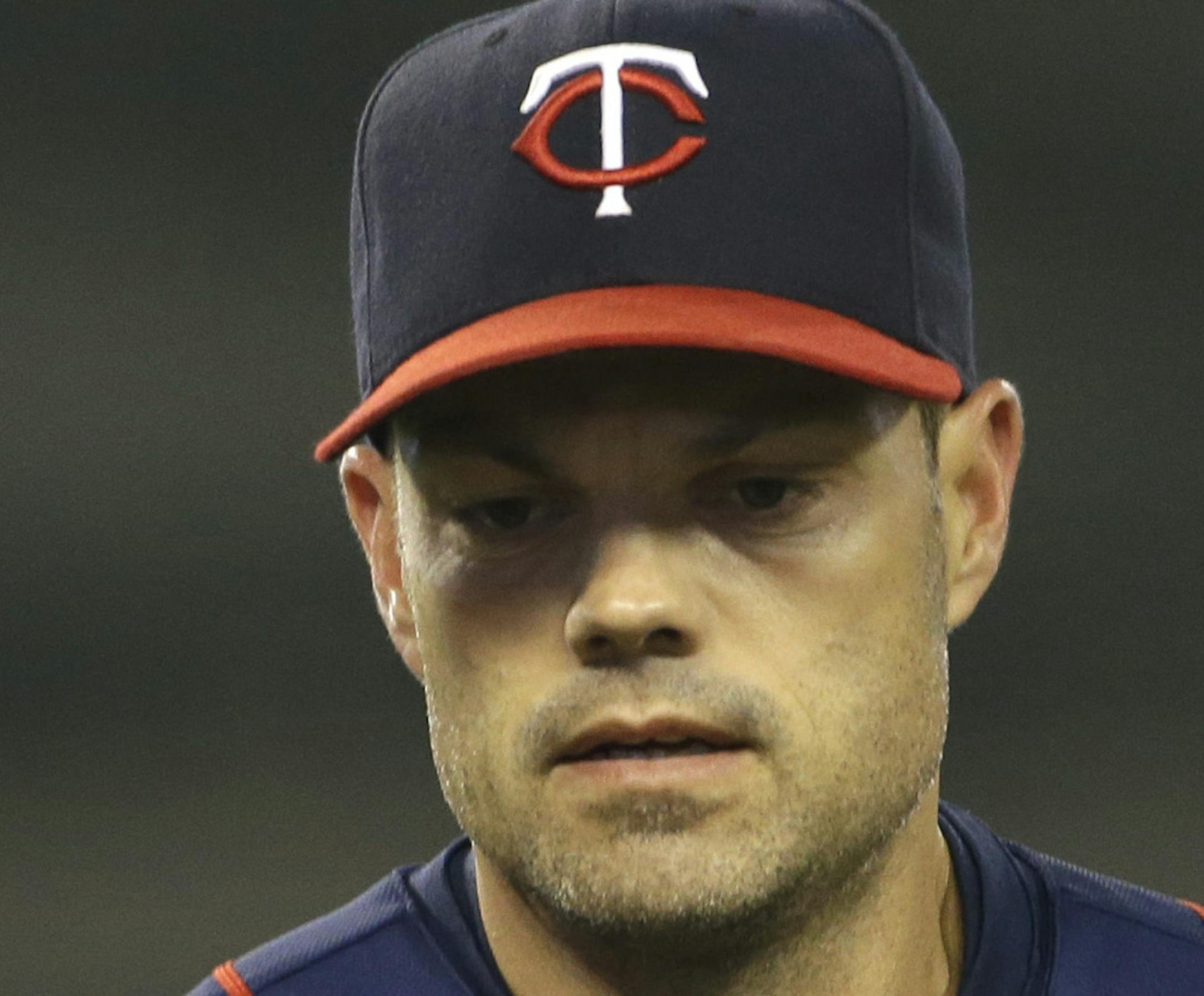 Minnesota Twins' Jamey Carroll runs back to the dugout during the fifth inning of a baseball game against the Detroit Tigers in Detroit, Thursday, May 23, 2013. (AP Photo/Carlos Osorio) ORG XMIT: MIN2013061122062716