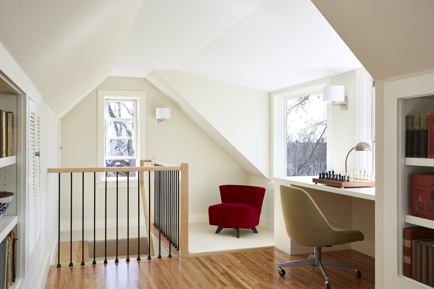 More windows, a skylight and built-in desks, bookshelves and file cabinet add lots of natural light and work layout space in the converted third-floor attic.