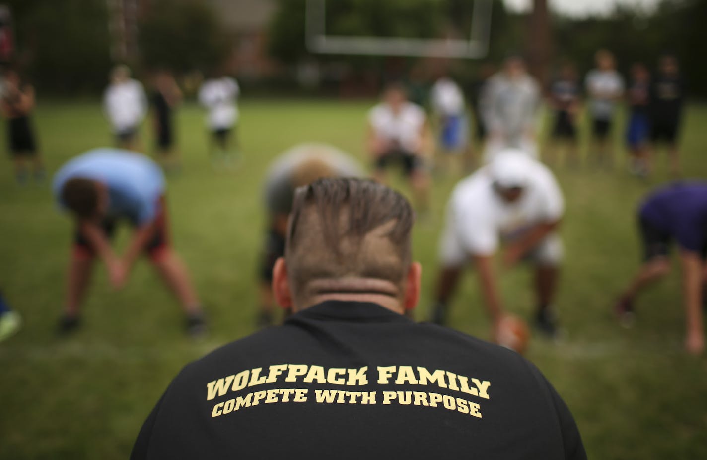 A coach wore the shirt with the name of the new team formed by the cooperative, the Wolfpack, at practice Monday afternoon at Minnehaha Academy. ] JEFF WHEELER &#xef; jeff.wheeler@startribune.com Three schools have formed a new football cooperative. The SPA-Minnehaha Academy-Blake (SMB) Wolfpack is the first football coop that can be traced to the decline in football participation. The team practiced at Minnehaha Academy Monday afternoon, August 24, 2015.