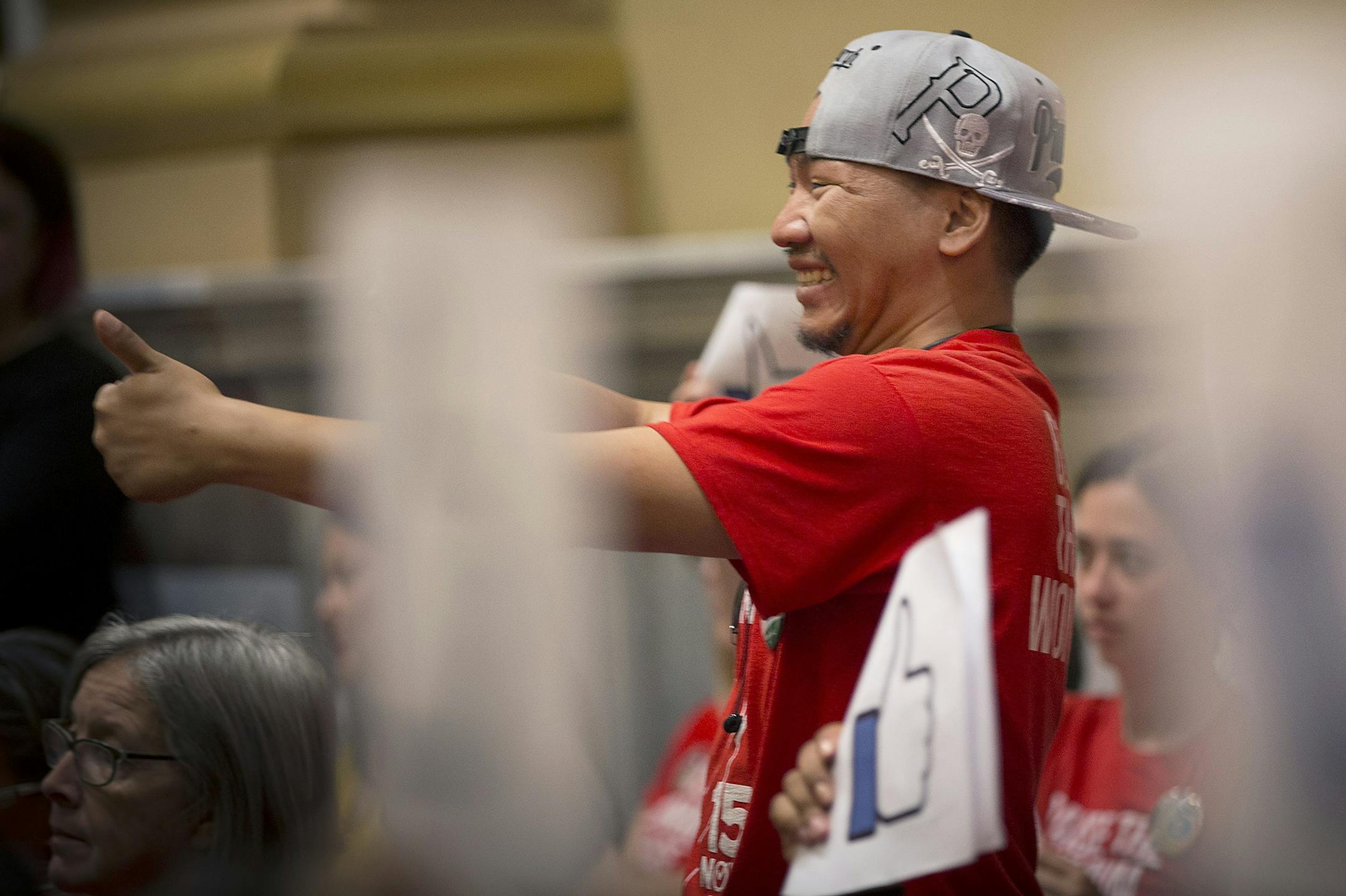 Local advocate Thao Pao Xiong celebrated with other supporters of the $15 minimum wage increase after it was passed by City Council at City Hall, Friday, June 30, 2017 in Minneapolis, MN.
