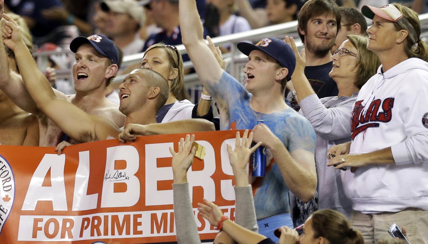 Minnesota Twins fans cheered for Canadian pitcher Andrew Albers as he led the Twins to a 3-0 shutout of the Cleveland Indians in a baseball game, Monday, Aug. 12, 2013 in Minneapolis, where they called for Albers to be Canada's prime minister. (AP Photo/Jim Mone) ORG XMIT: MNJM111