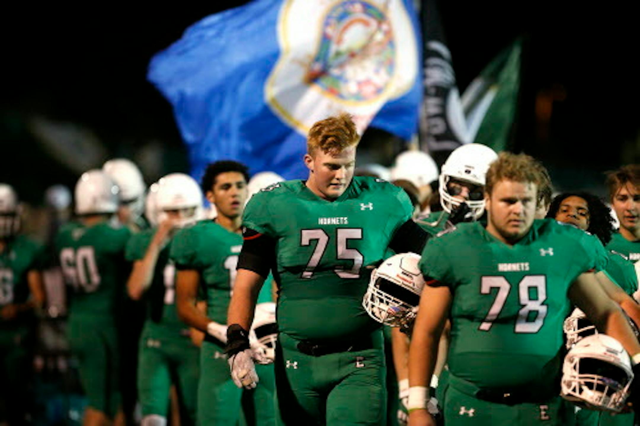 Edina High School offensive lineman Quinn Carroll (75) walks out with his teammates before the start of the game. ] LEILA NAVIDI ' leila.navidi@startribune.com