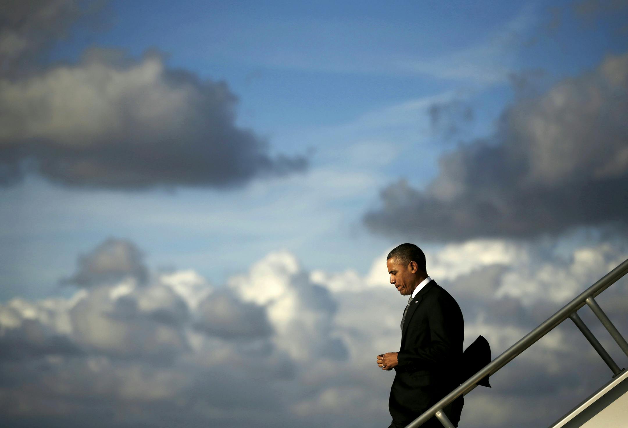 President Barack Obama steps off Air Force Oneupon his arrival at Miami International Airport, Friday, Nov. 8, 2013, in Miami. Obama traveled to the south Florida area for three Democratic fundraisers. (AP Photo/Pablo Martinez Monsivais)