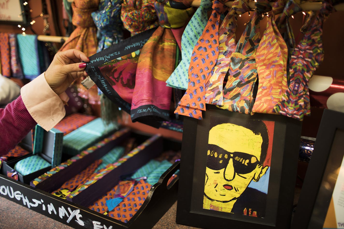 Scarves and bowties that were made from Jimmy Reagan's paintings.