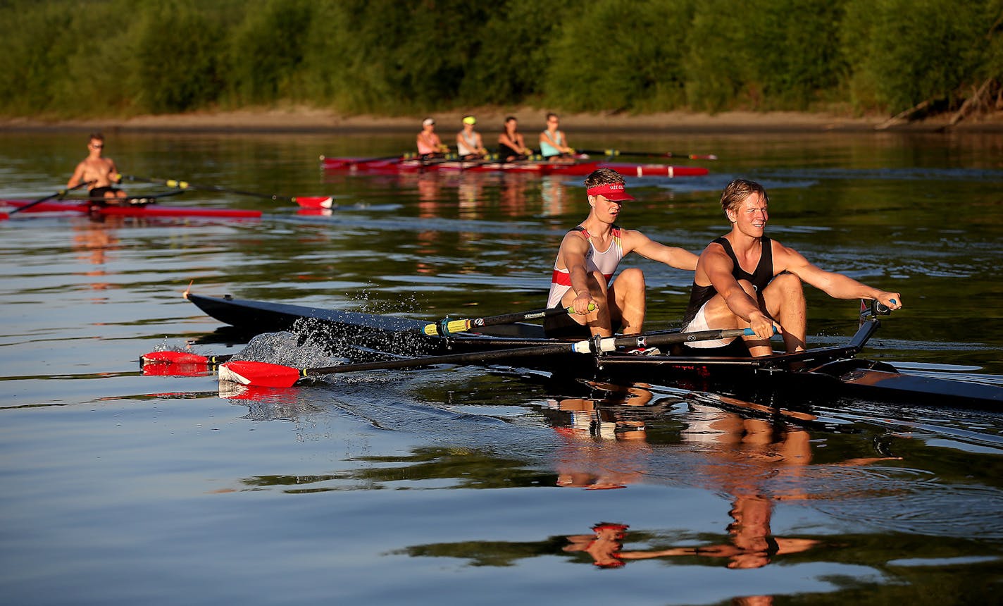 A flotilla of single, double and quad sculls made their way along the Mississippi River during a practice under the watchful eye of coach Miriam Baer.