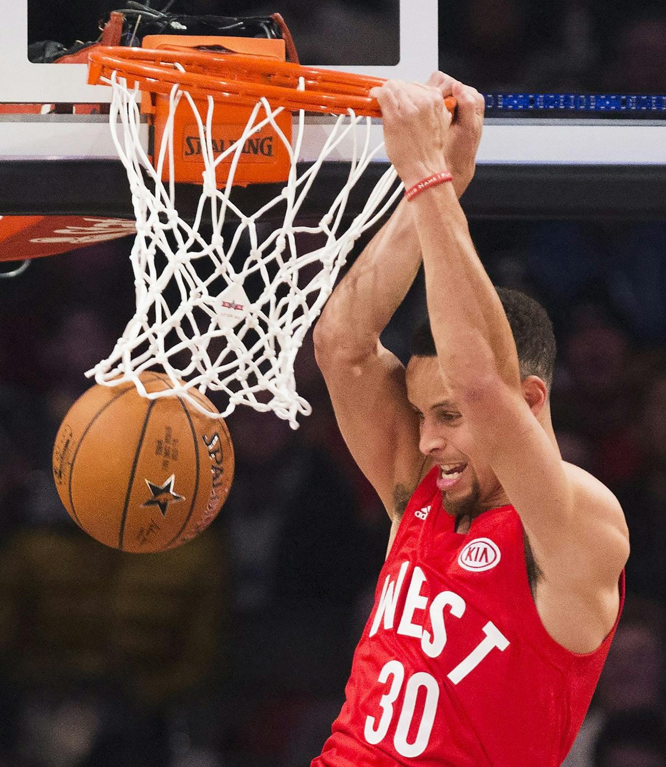 Western Conference's Stephen Curry, of the Golden State Warriors, (30) slam dunks the ball past Eastern Conference's Paul George, of the Indiana Pacers (13) during the first half of the NBA all-star basketball game, Sunday, Feb. 14, 2016 in Toronto. (Mark Blinch/The Canadian Press via AP) MANDATORY CREDIT