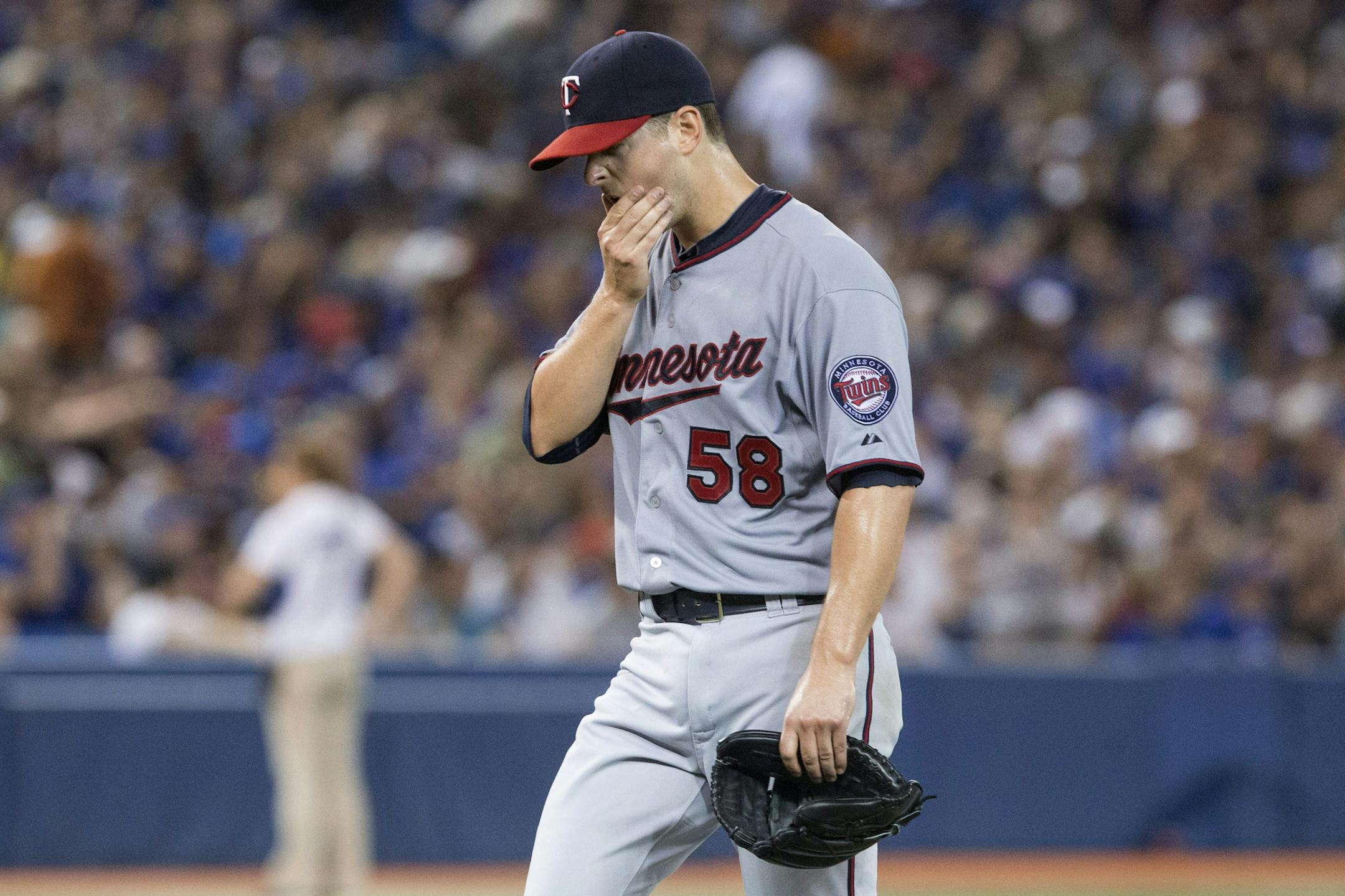 Minnesota Twins pitcher Scott Diamond reacts as he is pulled from the baseball game after giving up four runs to Toronto Blue Jays during the fifth inning in Toronto on Sunday, July 7, 2013. (AP Photo/The Canadian Press, Chris Young)