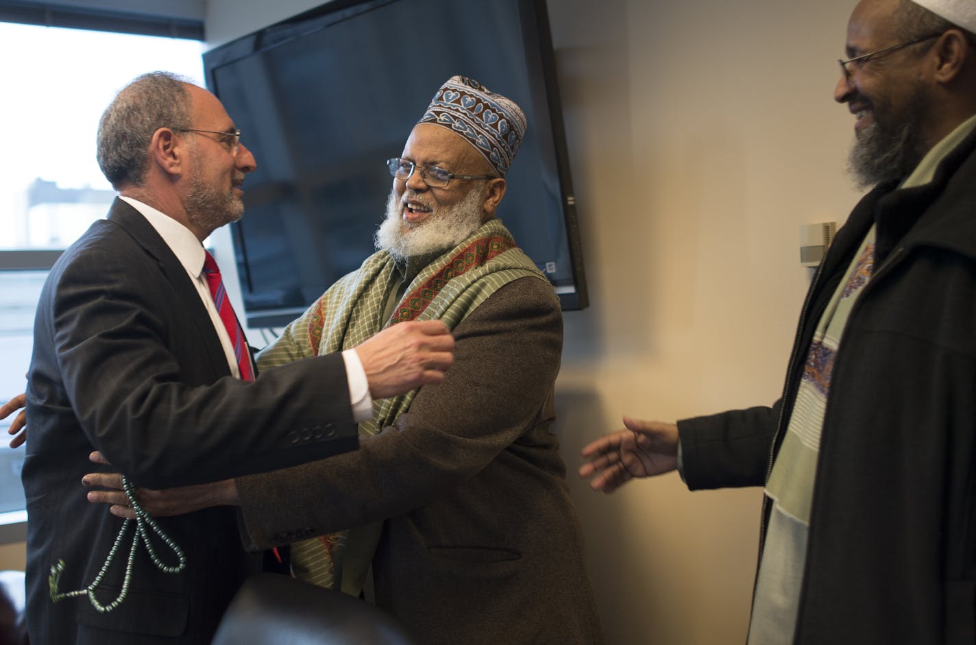 Imam Sheikh Sa&#x2019;ad Musse Roble, alongside Imam Ahmed Burale (right), had a warm greeting for U.S. Attorney Andy Luger before a Somali community meeting in Minneapolis.