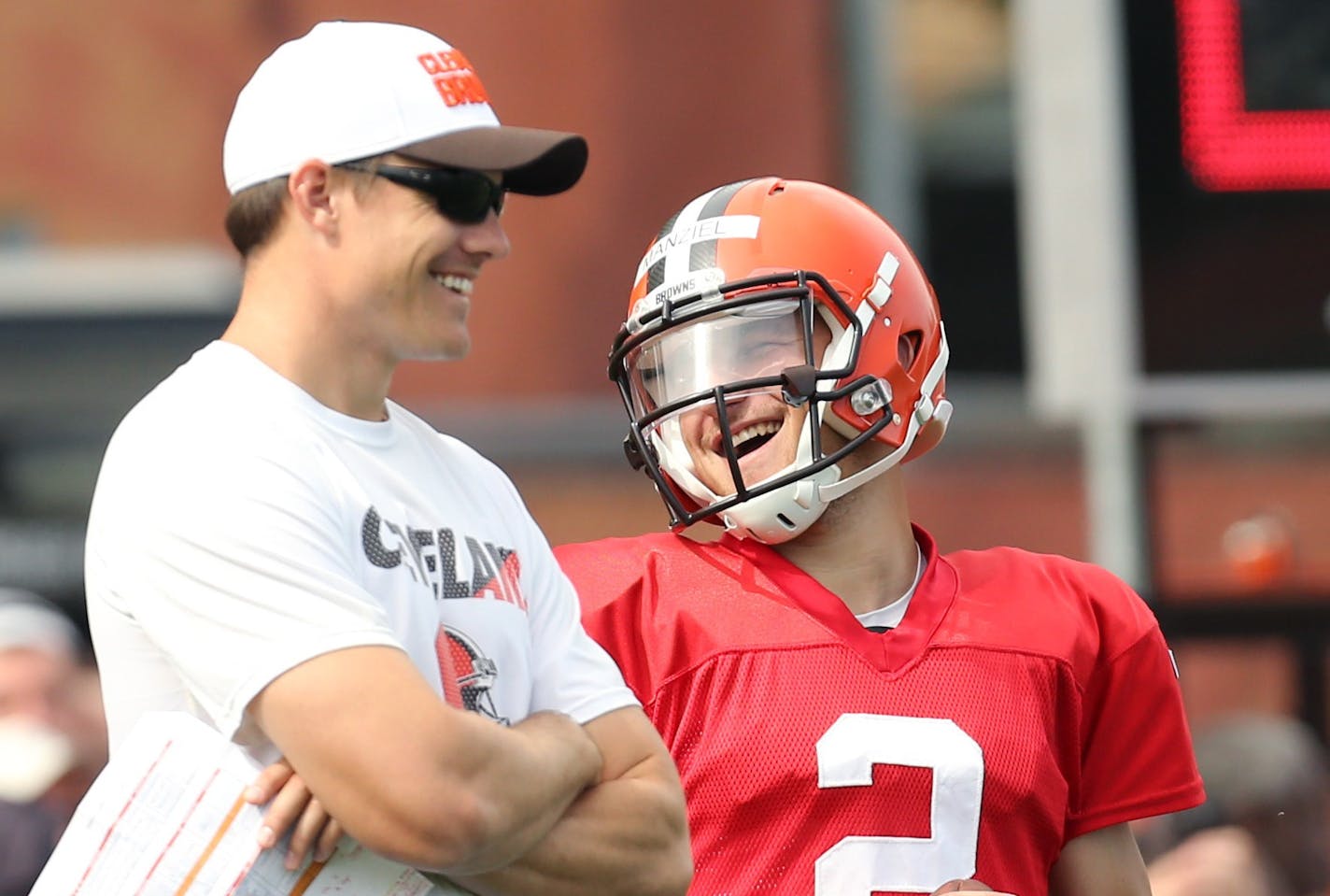 Cleveland Browns quarterback Johnny Manziel jokes with quarterbacks coach Kevin O'Connell during NFL training camp, Thursday, Aug. 6, 2015 in Berea, Ohio. (John Kuntz/The Plain Dealer via AP) MANDATORY CREDIT; NO SALES