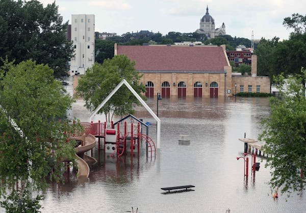 The Harriet Island pavilion and playground are surrounded by the flood waters of the Mississippi River, Tuesday, in St. Paul.