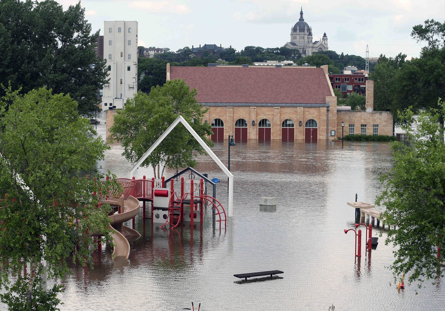 The Harriet Island pavilion and playground are surrounded by the flood waters of the Mississippi River, Tuesday, in St. Paul.