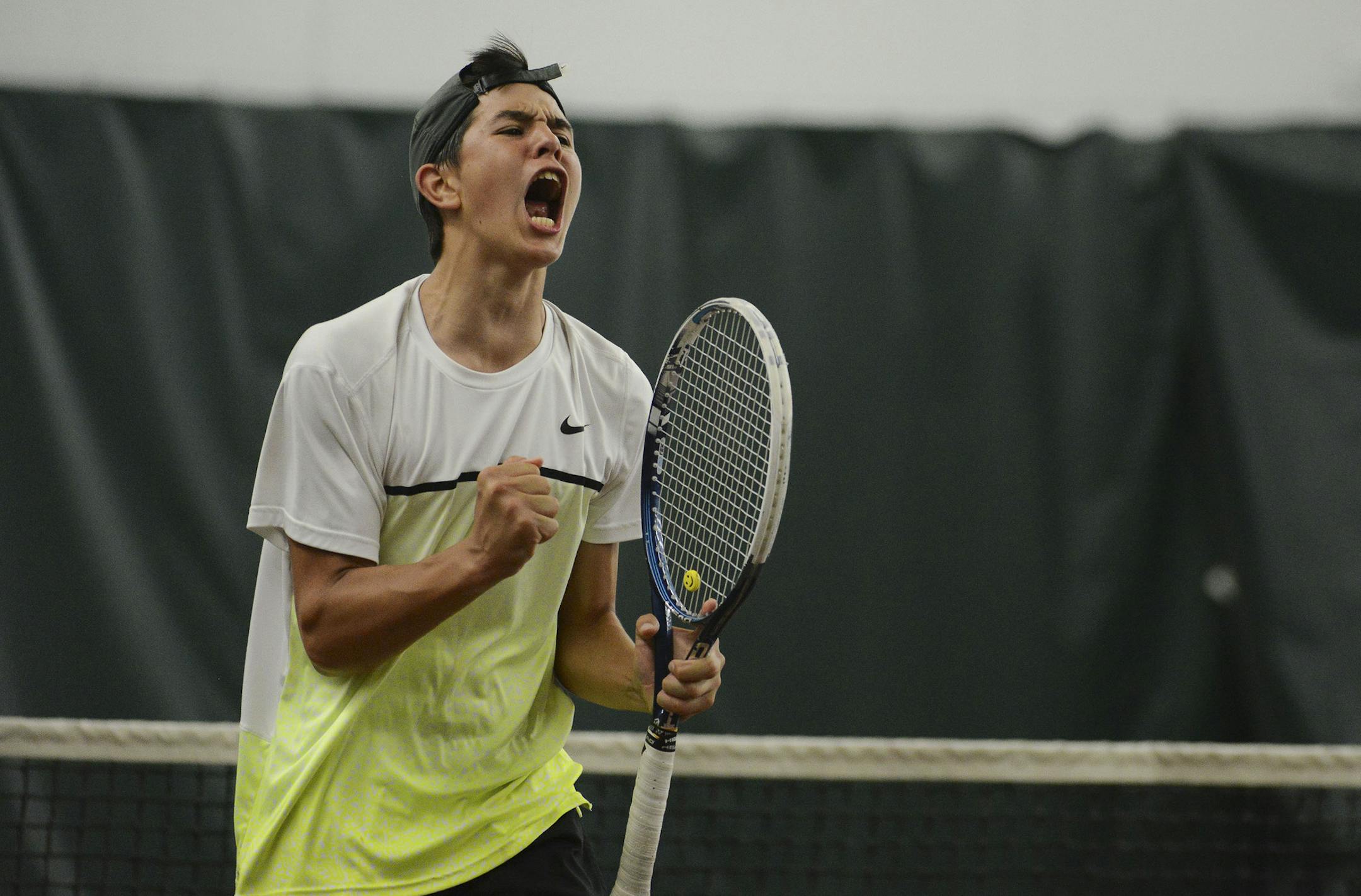 Petro Alex, of Mounds View High School, screams minutes before hitting the ball to win his match against Zeke Delain, of Elk River High School. Petro's win was the deciding factor in Mounds View's State Tennis Tournament victory over Elk River on Wednesday June 3, 2015. ] RACHEL WOOLF rachel.woolf@startribune.com