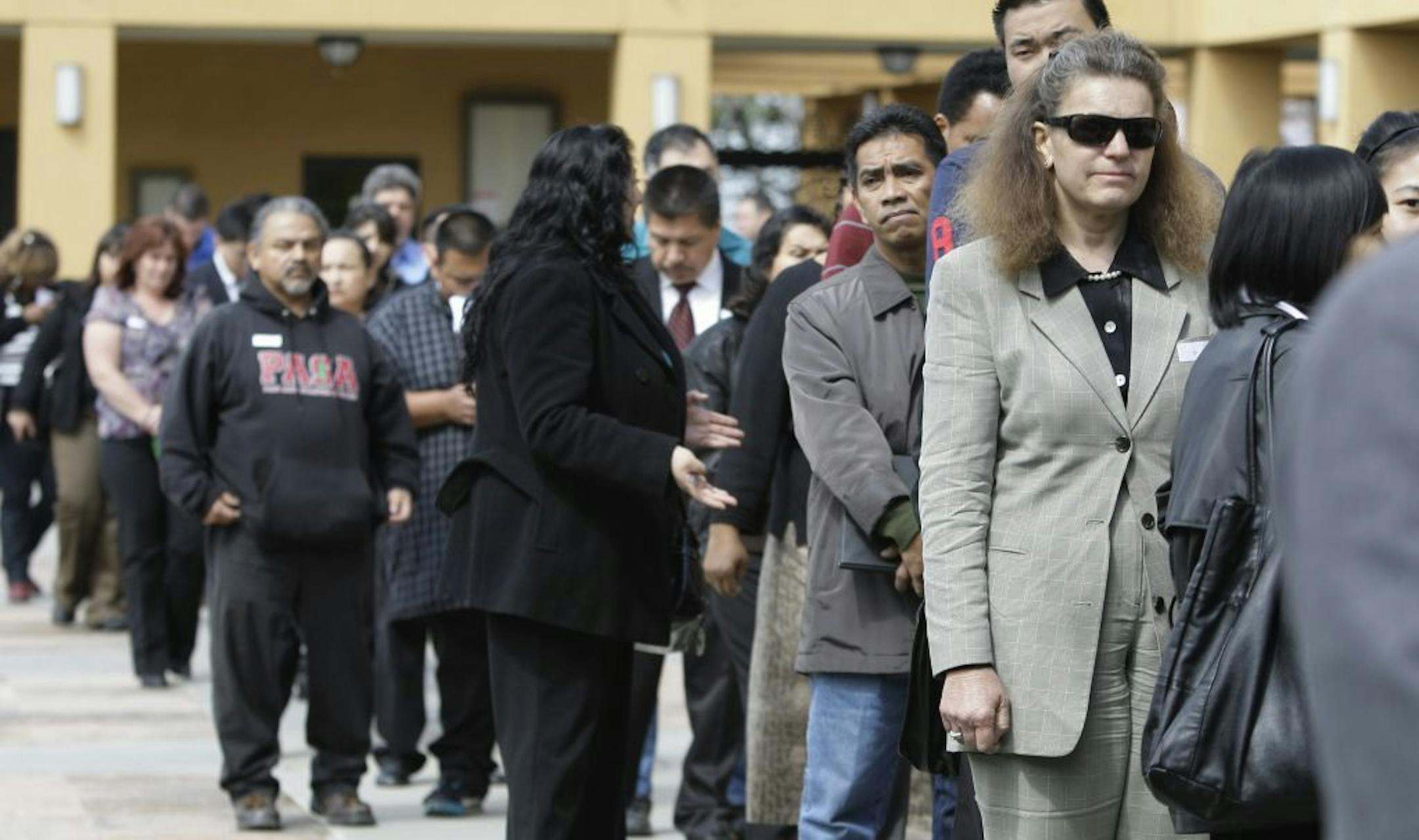 Job applicants wait in a long line at a job fair in San Jose, Calif., last year.
