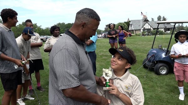 Darwin Dean handed the first-place trophy to Mateo Martinez, winner of the 2019 Junior Bronze tournament for 7- to 10-year-olds at Hiawatha Golf Club.