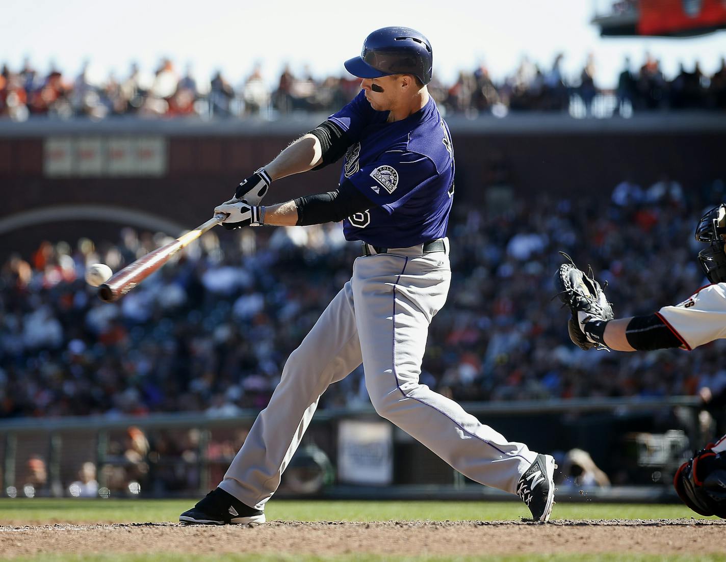 Colorado Rockies' Justin Morneau hits a single to drive in two runs against the San Francisco Giants during the ninth inning of a baseball game, Sunday, Oct. 4, 2015, in San Francisco. (AP Photo/Tony Avelar) ORG XMIT: CATA120