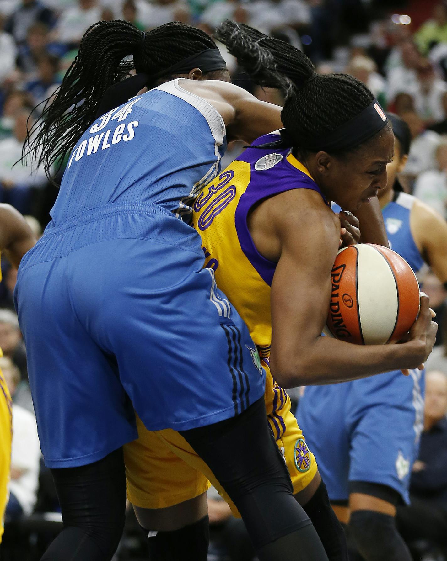 Los Angeles Sparks forward Nneka Ogwumike (30) fights for a rebound bound against Minnesota Lynx center Sylvia Fowles (34) in the second half of Game 1 of the WNBA basketball finals Sunday, Oct. 9, 2016, in Minneapolis. Los Angeles won 78-76. (AP Photo/Stacy Bengs)