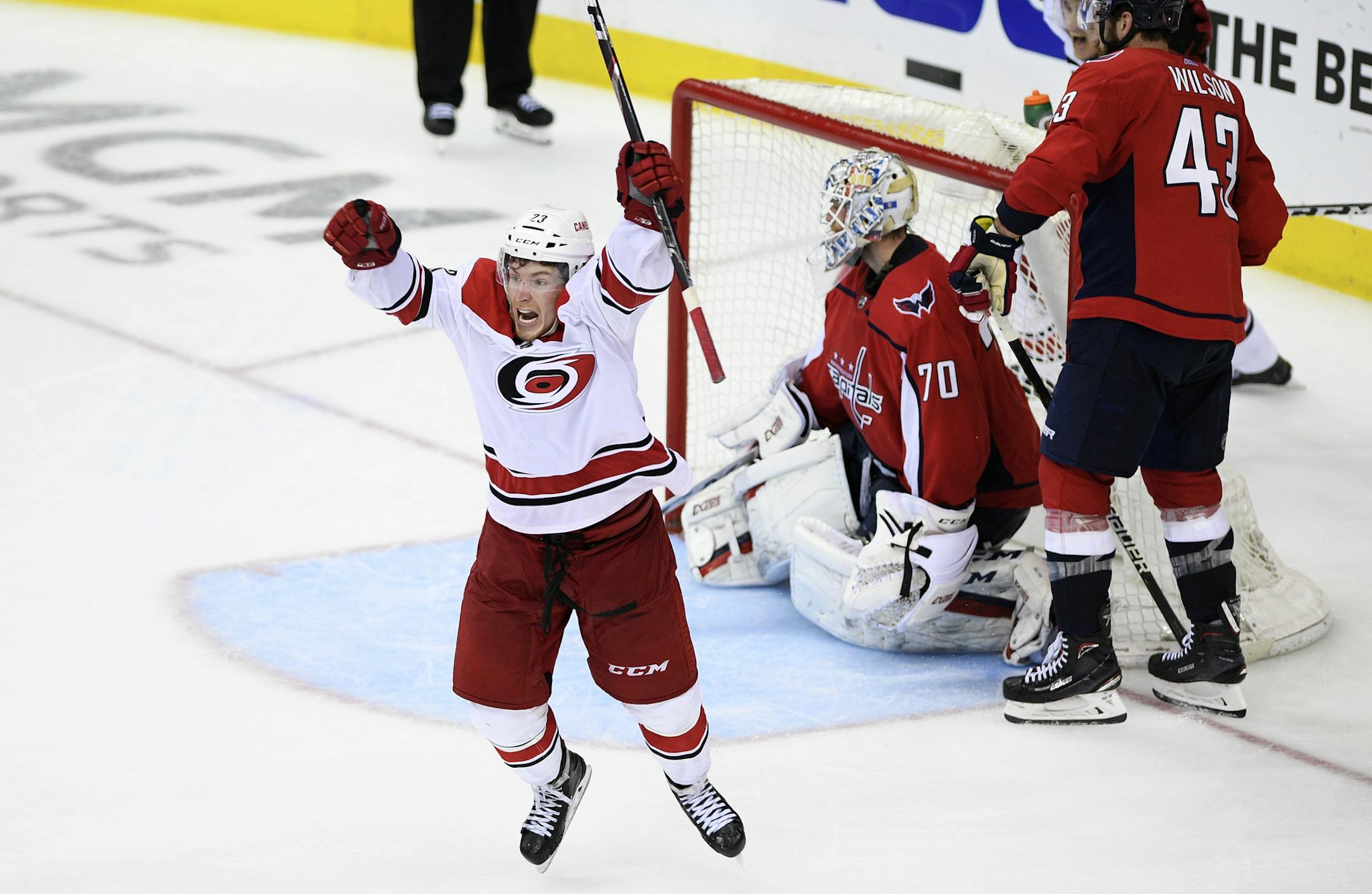 Carolina Hurricanes left wing Brock McGinn, left, celebrates his game-winning goal during double overtime of Game 7 of an NHL hockey first-round playoff series against Washington Capitals goaltender Braden Holtby (70) and right wing Tom Wilson (43), Wednesday, April 24, 2019, in Washington. The Hurricanes won 4-3 in double overtime. (AP Photo/Nick Wass)