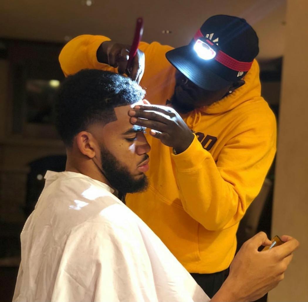 Akeem Akway cutting Karl-Anthony Towns' hair in October, 2018.