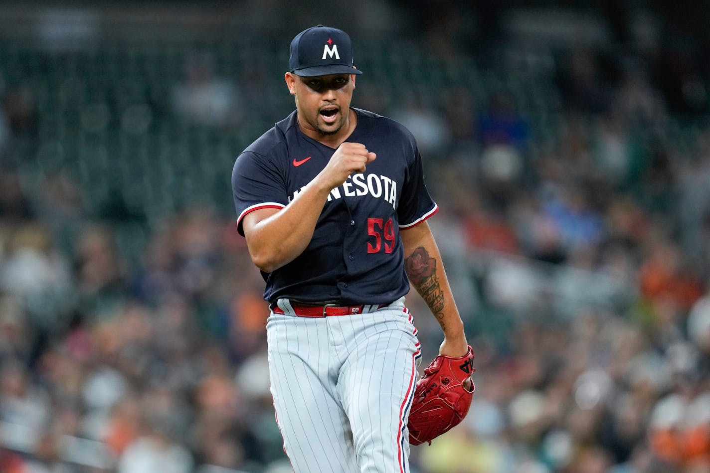 Minnesota Twins relief pitcher Jhoan Duran reacts after the final out against the Detroit Tigers in the ninth inning of a baseball game, Friday, June 23, 2023, in Detroit. (AP Photo/Paul Sancya) ORG XMIT: MER6c27a10a84836b4155a695722912b