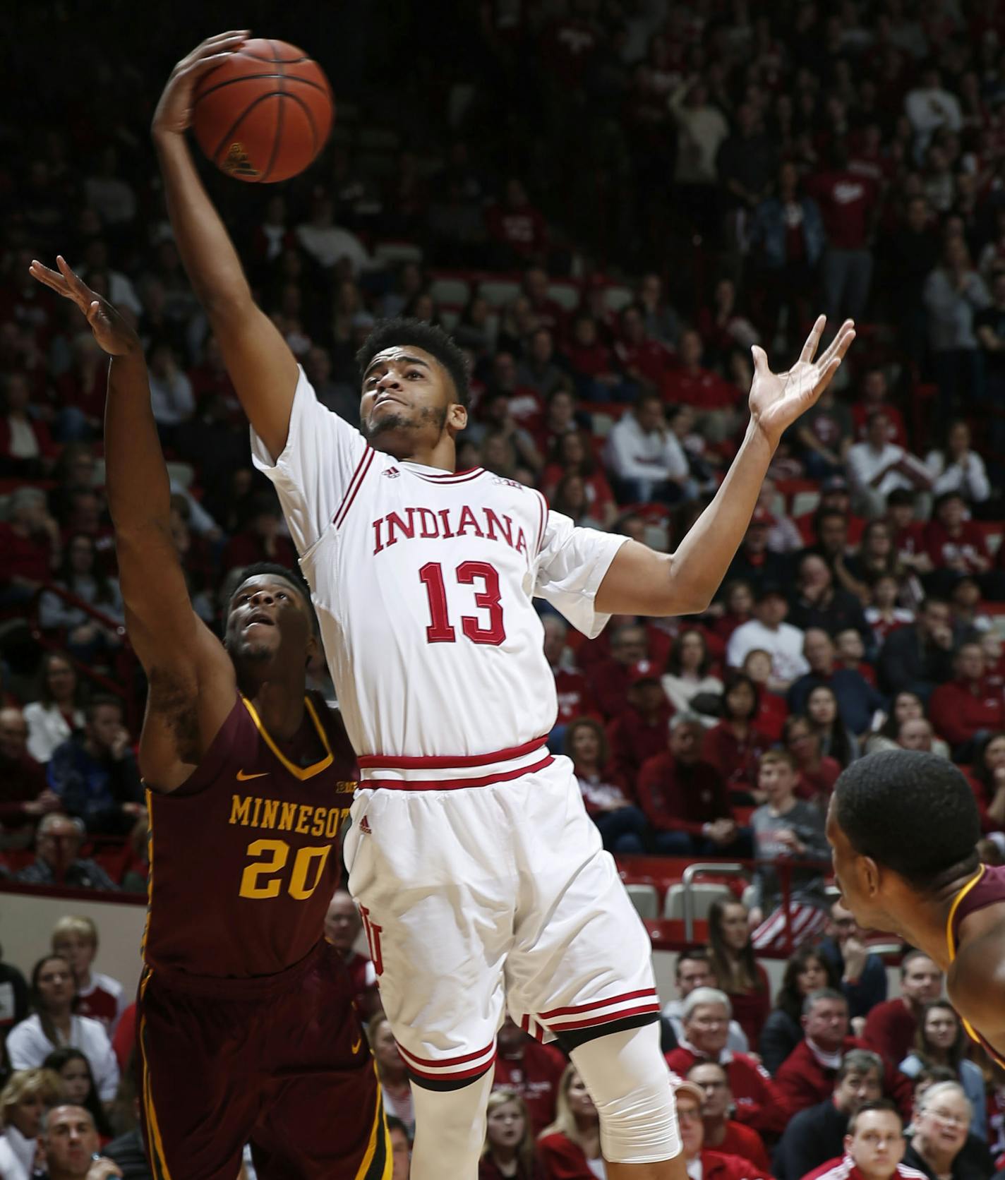 Indiana forward Juwan Morgan (13) pulls down rebound in front of Minnesota forward Davonte Fitzgerald (20) during the first half of an NCAA college basketball game in Bloomington, Ind., Friday, Feb. 9, 2018. (AP Photo/AJ Mast)