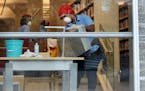 Workers sanitize furniture at Minneapolis Central Library in downtown in March.