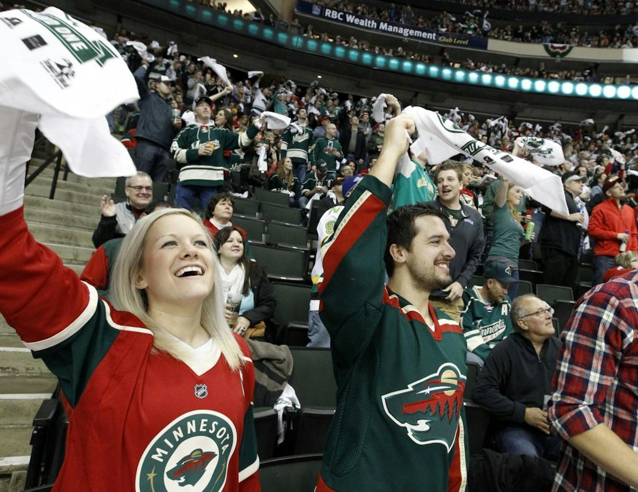 Minnesota Wild fans cheer after their team's only goal during the second period of Game 4 of an NHL hockey first-round playoff series game against the St. Louis Blues in St. Paul, Minn., Wednesday, April 22, 2015.