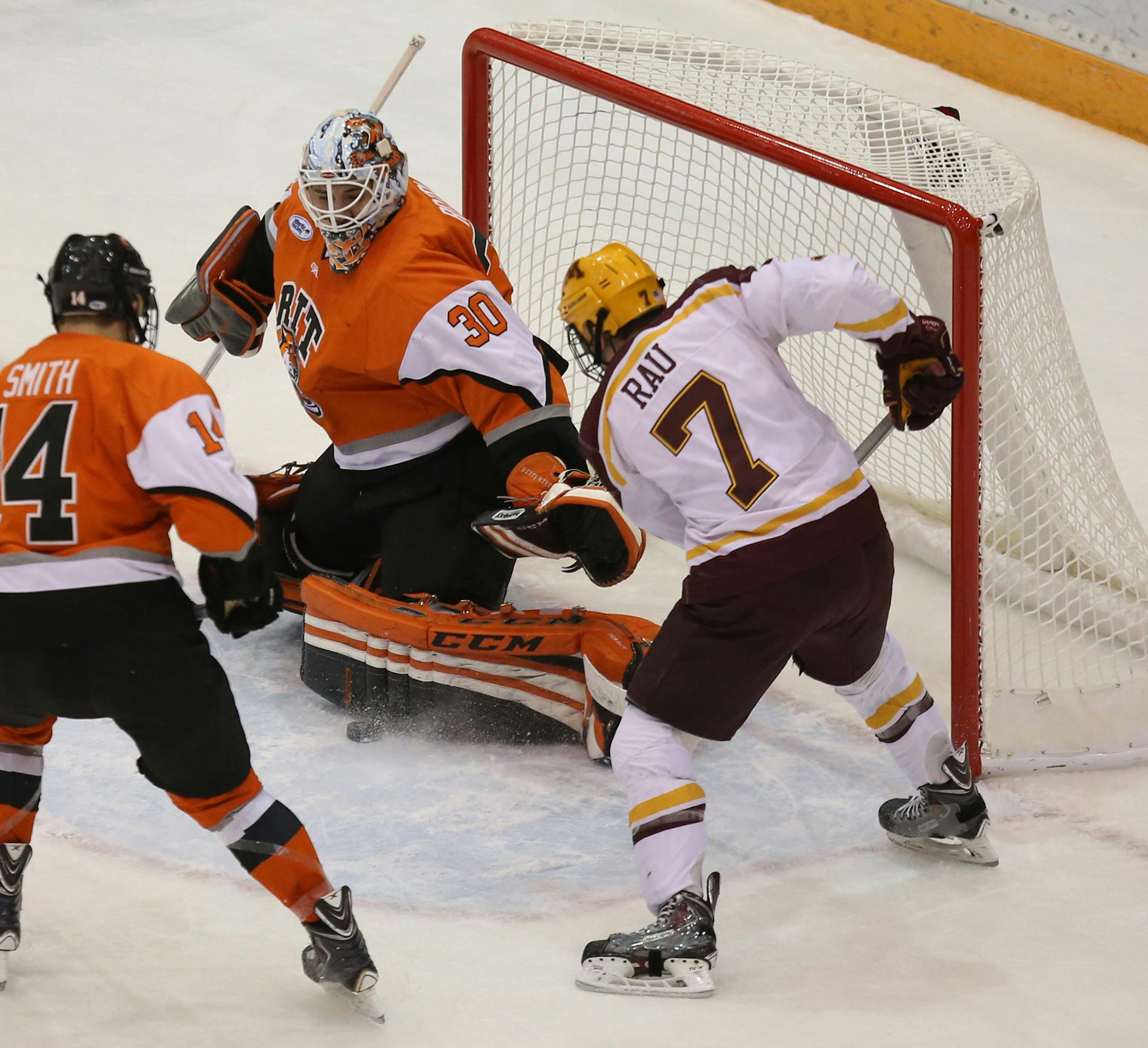 Gophers Kyle Rau tried to get the puck passed RIT's goalie Mike Rotolo during the first period. ] (KYNDELL HARKNESS/STAR TRIBUNE) kyndell.harkness@startribune.com Mariucci Classic Gophers vs RIT at Mariucci Arena in Minneapolis Min., Saturday, January 3, 2014.