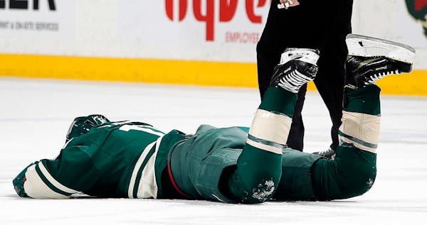The Wild's Zach Parise (11) was hit in the face with a high stick by Washington's Tom Wilson in the first period Tuesday night. ] CARLOS GONZALEZ � 