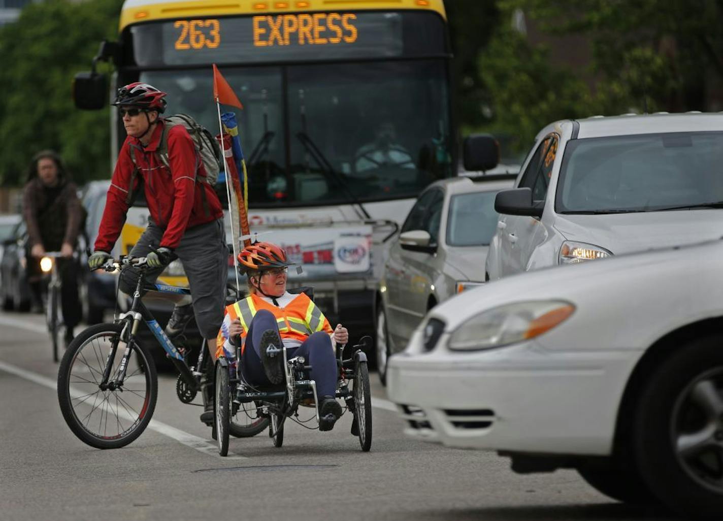 Cyclists negotiate the evening rush hour traffic on Portland Avenue near the corner of Franklin in south Minneapolis. On World Car-Free Day, the city is asking its 160,000 downtown workers to find a new route to work.