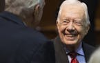 FILE -- Former President Jimmy Carter greets people before speaking at a news conference at The Carter Center in Atlanta, Aug. 20, 2015. In an intervi