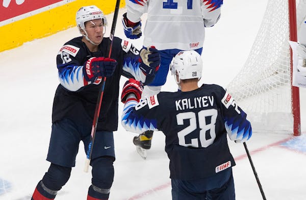 United States’ Matthew Boldy and Arthur Kaliyev  celebrate a goal against Slovakia during the world junior tournament in Edmonton.