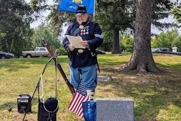 Jim Johnson at the gravesite of John Bennington Clark, the last Union veteran buried in Koochiching County, at Forest Hill Cemetery in Northome. Clark