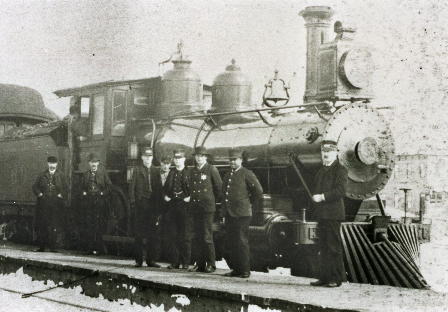 For BLACK HISTORY MONTH (Feb 2000) -- JOHN BLAIR, hero of Hinckley MN fire of 1894 -- THIS PHOTO copied Feb 10, 2000, Minnesota Historical Society (St. Paul) -- HE62N/P14 (original removed for preservation) -- Shown is a St. Paul and Duluth R.R. Co. train and several railroad men, including John W. Blair (2nd from right), a porter on a St. Paul and Duluth R.R. train which escaped the 1894 Hinkley fire. Engine #69 in photo was part of that train. Historical note -- in 1900 the St. Paul and Duluth