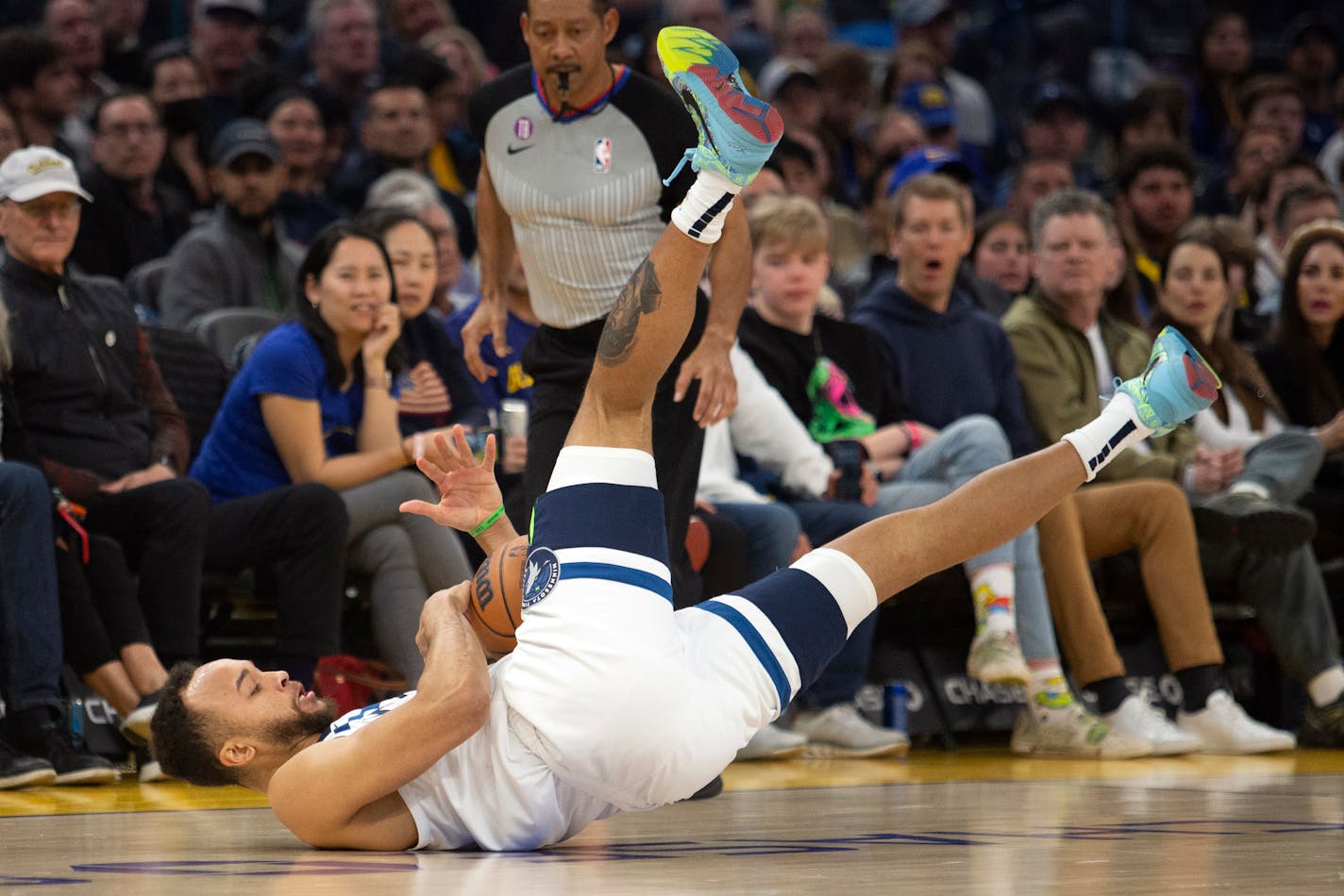 Minnesota Timberwolves forward Kyle Anderson loses his footing while bring the ball upcourt against the Golden State Warriors during the first quarter of an NBA basketball game, Sunday, March 26, 2023, in San Francisco. (AP Photo/D. Ross Cameron)