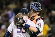 Houston Astros' Ken Giles, left, is hugged by Jason Castro after the Astros defeated the Pittsburgh Pirates 3-1 in Pittsburgh, Monday, Aug. 22, 2016. 