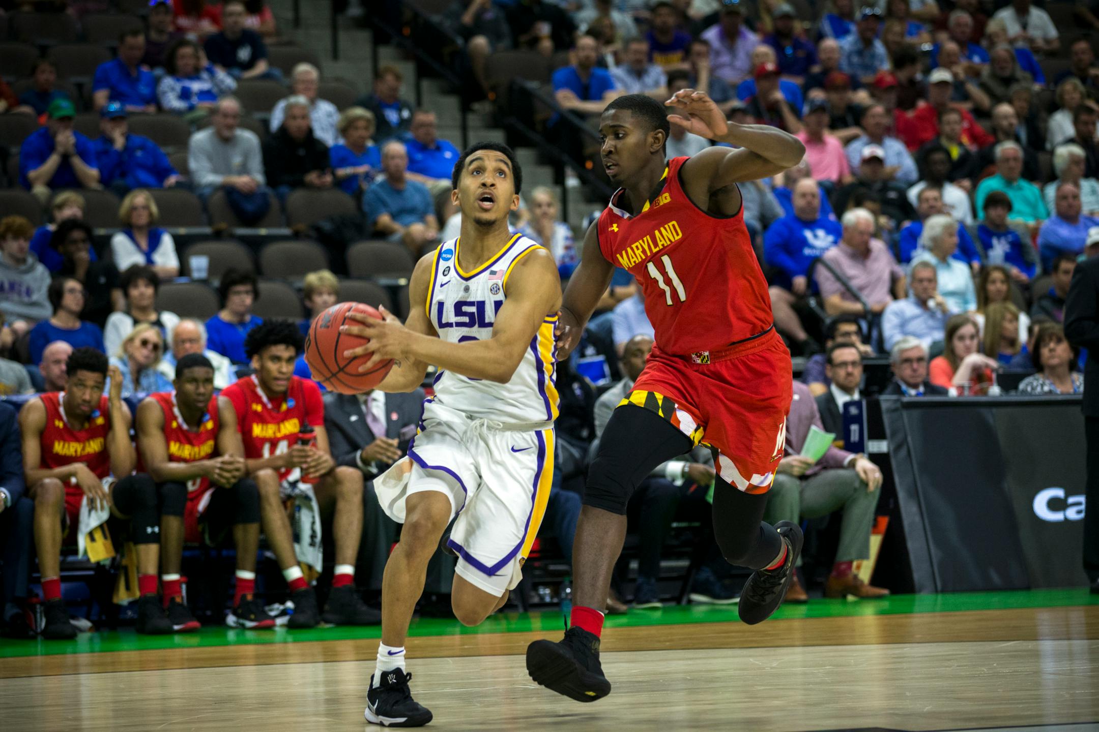 LSU guard Tremont Waters (3) drives to the basket against Maryland guard Darryl Morsell (11) during the first half of the second round men's college basketball game in the NCAA Tournament, in Jacksonville, Fla. Saturday, March 23, 2019. (AP Photo/Stephen B. Morton)