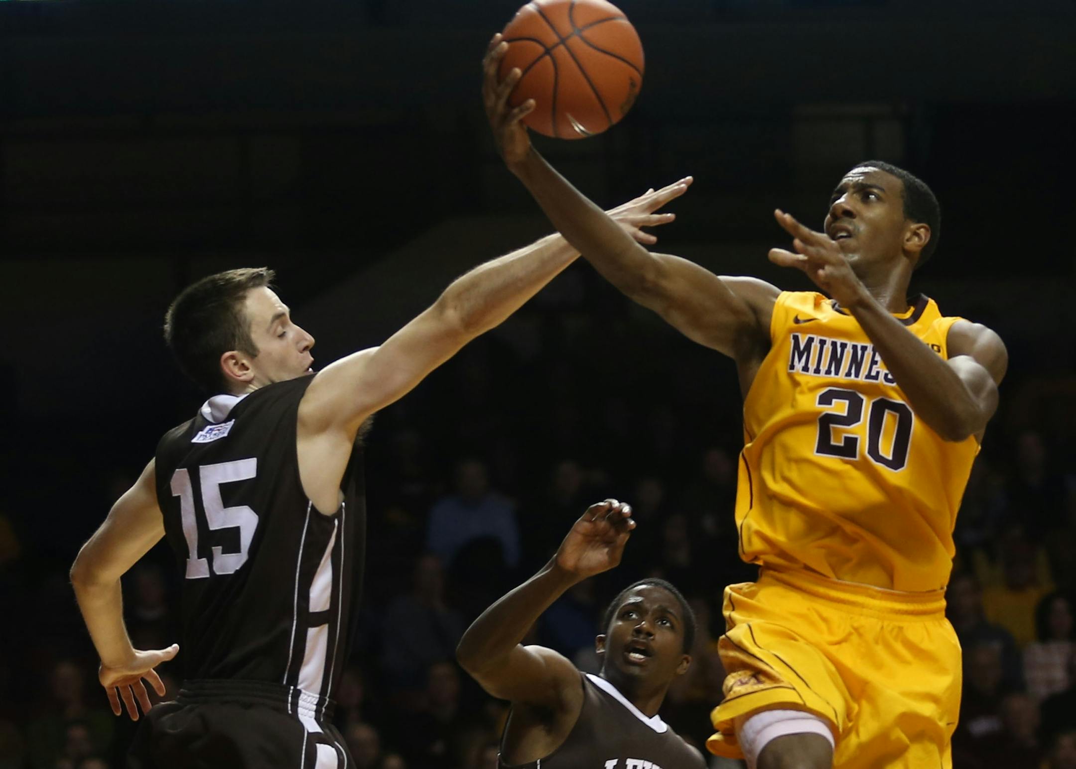 Gopher Austin Hollins went to the basket with Lehigh's Corey Schaefer defending during the second half at Williams Arena in Minneapolis, Min., Friday, November 8, 2013. Gophers won over Lehigh 81-62.