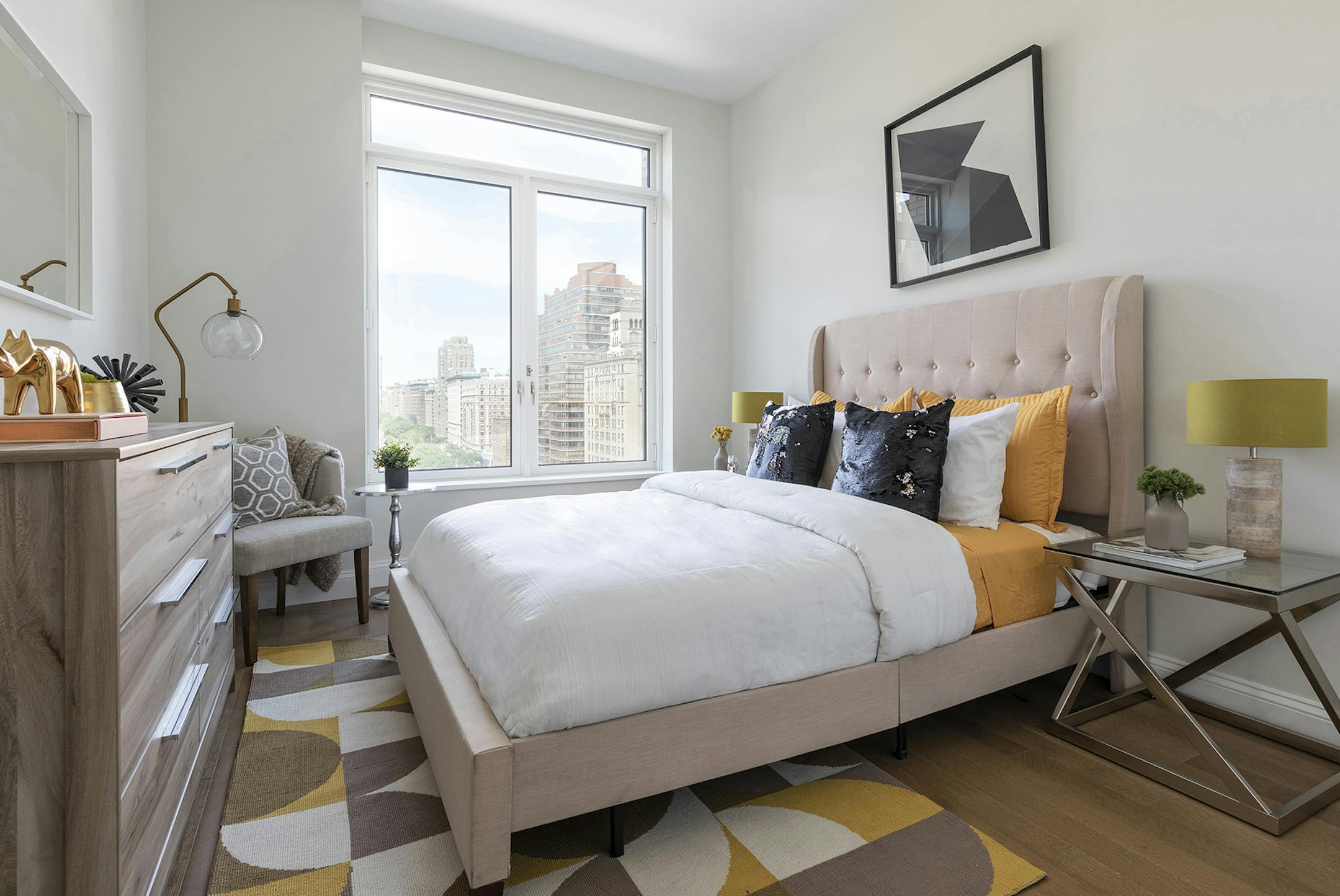 A bedroom is glammed up through the mix of a classic gold and black color combination.