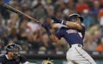 Minnesota Twins' Ehire Adrianza follows through on his grand slam during the seventh inning of a baseball game against the Detroit Tigers, Tuesday, Ju
