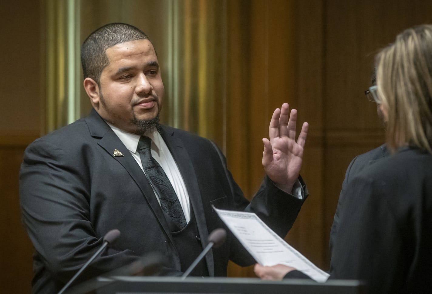 City Council Member Kassim Busuri, left, was sworn in by City Clerk Shari Moore at St. Paul City Hall, Wednesday, February 6, 2019 in St. Paul, MN. Busuri, a local educator, is the first Somali-American to serve on the St. Paul City Council.